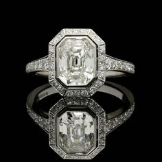 an old mine cut diamond ring set in 18k white gold with diamonds surrounding it