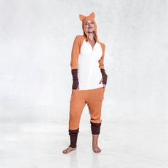 Our fox suit is so comfy and stretchy, you'll never want to take yours off. Perfect to wear all year round, to birthday parties, Halloween parties, Burning Man, or any celebration or event you have planned. We pride ourselves on making the most detailed, unique animal suits out there for creatures big and small. We use 100% cotton, which we knit using a hand drawn flat knitting machine. A very time intensive process, but worth it for the durable result. FEATURES 100% orange, white, and brown cot Fox Onesie, Animal Pajamas, Cozy Loungewear, Halloween Parties, Knitting Machine, Unique Animals, Burning Man, Machine Knitting, Orange White