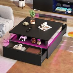 a living room with a couch, coffee table and entertainment center in the middle on carpeted flooring