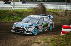 a car driving down a dirt road with mud pouring out of the front and sides