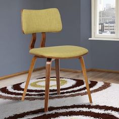 a yellow chair sitting on top of a white rug