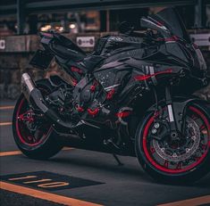 a black and red motorcycle parked on the street