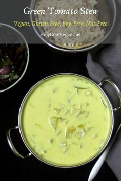 green tomato soup in a bowl with rice and other dishes around it on a black surface