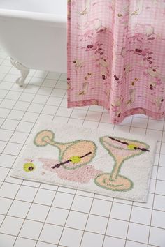 a bathroom with a pink shower curtain and bath mat on the floor next to a tub