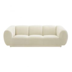 a white couch sitting on top of a white floor