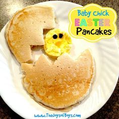 a white plate topped with pancakes covered in butter and eggs next to a smiley face