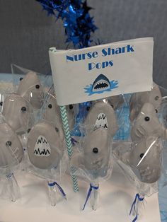 several plastic shark pops are on display with a sign in the background that says nurse shark pops