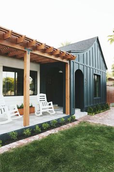 an outdoor patio with white chairs and wooden pergolan arbors on the side