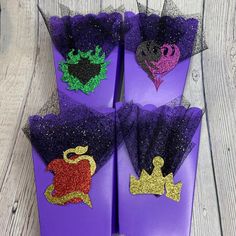 three purple shoes with princess crowns on them