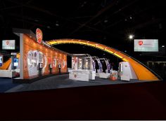 an exhibition stand with orange and white displays