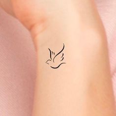 a small bird tattoo on the wrist