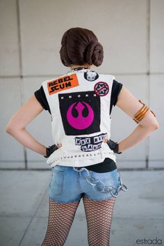 a woman with her back to the camera wearing a star wars t - shirt and fishnet tights