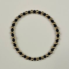 This listing is for a custom 14k gold filled 4mm beaded bracelet with alternating black colored seed beads. Each bracelet can be personalized to your desired length. These bracelets will not tarnish and look great alone or in a stack! Bracelets come in an organza pouch and make perfect gifts. Bracelets are made on elastic cord and will stretch to fit over your hand. Please contact me with any questions. Gifts Bracelets, Stack Bracelets, Organza Pouch, Initial Bracelet, Gem Stones, Personalized Initials, Photo Bracelet, Black Beads, Gold Beads