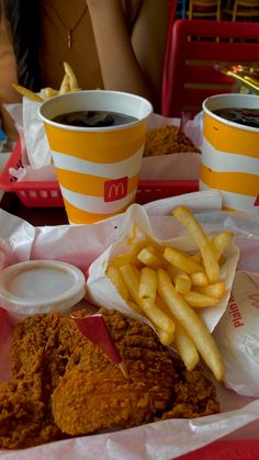 fried chicken and french fries on a tray at a restaurant