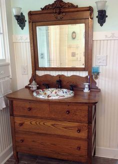 a bathroom vanity with a mirror above it