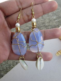 Aqua Chalcedony and freshwater pearl earrings with cowrie shells. Beach Wire Wrapped Teardrop Earrings, Beach Teardrop Wire Wrapped Earrings, Unique Teardrop Jewelry For Beach, Beach Drop Earrings In Mother Of Pearl, Beach Wire Wrapped Drop Earrings, Unique Beach Drop Earrings, Unique Beach Style Drop Earrings, Mother Of Pearl Drop Earrings For Beach, Unique Blue Jewelry For Vacation