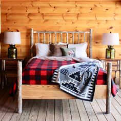 a bed in a room with wooden walls