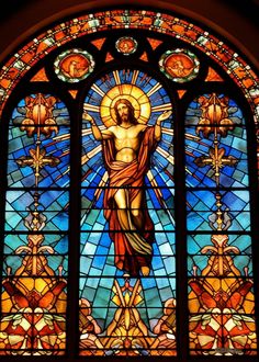 a stained glass window with jesus on it