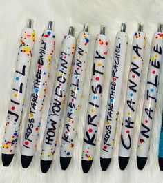 five pens with writing on them sitting next to each other