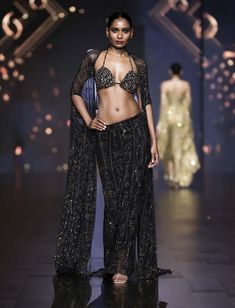 This stunning skirt features intricate hieroglyphic crystal embellishments which has ruching effect and trail on the back. Paired with a blouse featuring striking big stones and a flowing cape. Desert Mirage, Cape Set, Crystal Embellishment, Black Skirt, Cape, Embellishments, Skirt, Black