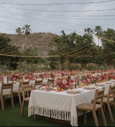 an outdoor wedding reception setup with tables and chairs