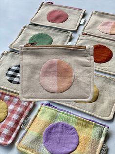 four small pouches with different colored circles on them