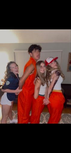 group of young people dressed in orange and white posing for the camera with their arms around each other