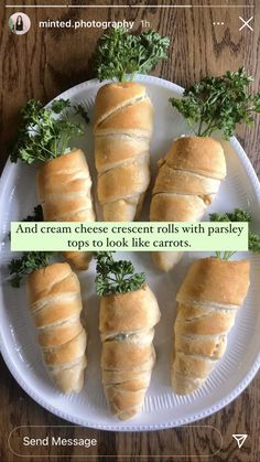 four croissant rolls with parsley on top to look like carrots in the middle