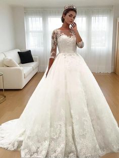 a woman in a white wedding dress is taking a selfie with her cell phone