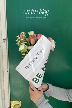 a woman holding a bouquet of flowers in front of a green door with the words best wedding times written on it