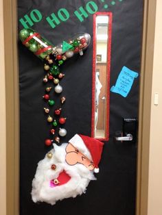 a door decorated for christmas with santa clause