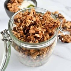 cinnamon raisin granola in a glass jar with spoons