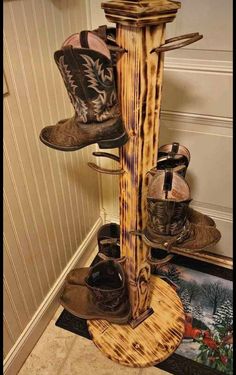 there is a wooden pole with cowboy boots on it and other items in the corner