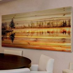 a painting hanging on the wall above a dining room table