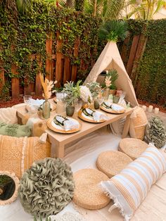 a picnic table set up with plates and place settings