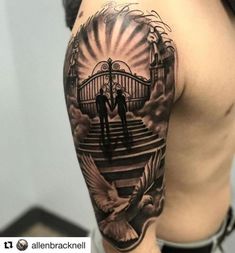 a man with a tattoo on his arm is standing in front of an open gate