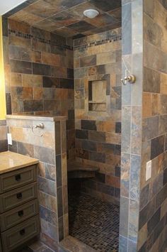 a walk in shower sitting inside of a bathroom