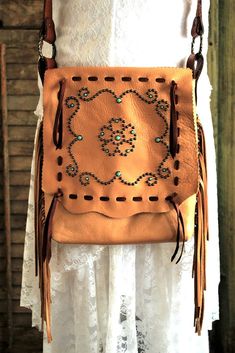 Western Style Hand Tooled Brown Bag, Western Style Brown Bag With Concho, Bohemian Leather Saddle Bag, Western Brown Bag With Fringe, Brown Western Bag With Fringe, Western-themed Brown Leather Shoulder Bag, Western Leather Bag With Fringe, Leather Hand Tooled Shoulder Bag For Western-themed Events, Bohemian Brown Bags With Concho