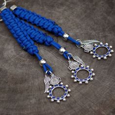 three blue lanyards with silver bells and beads