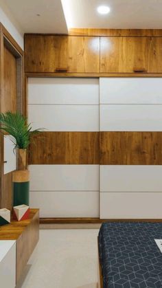 a bed sitting in a bedroom next to a wall with wooden paneling on it