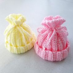 two knitted hats sitting next to each other