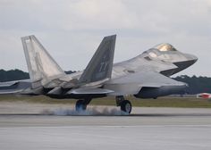 a fighter jet taking off from an airport runway