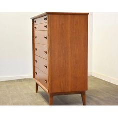 a wooden dresser with five drawers on one side