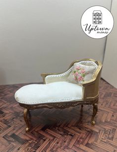 a miniature chair sitting on top of a wooden floor