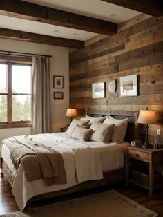 a bedroom with wood paneling and white bedding in front of a large window