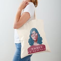 a woman carrying a tote bag with the words women in science printed on it