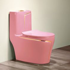 a pink toilet sitting on top of a hard wood floor next to a white wall