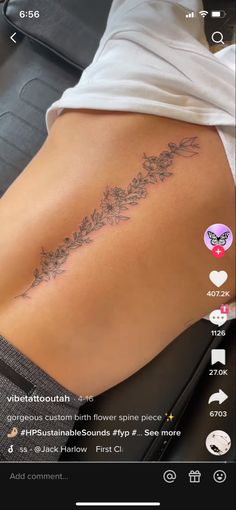 the back of a woman's stomach with flowers on it