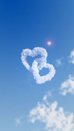 a heart shaped cloud floating in the sky