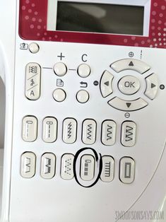 a white and red remote control sitting on top of a table